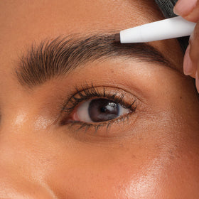 jane iredale PureBrow applied in front of mirror for groomed brows