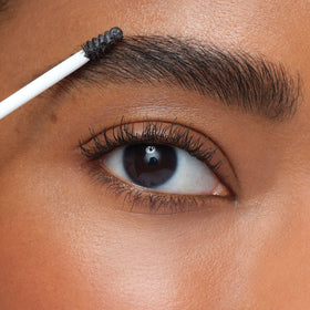 jane iredale brow gel size comparison beside a compact to show travel-friendly portability