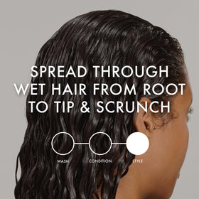 John Frieda lifestyle shot with beach waves showcasing soft, touchable curl results