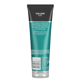 Hand holding John Frieda bottle for scale showing travel-friendly size