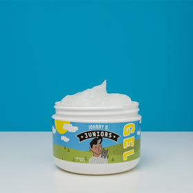 8 oz JOHNNY B. jar next to a ruler illustrating size for travel and countertop storage
