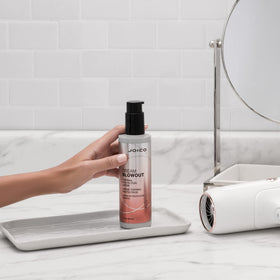 Joico product in use during blow-dry, demonstrating faster drying and frizz control