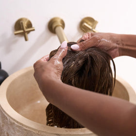 Jon Renau sprayed onto wig while styling to ease brushing benefit