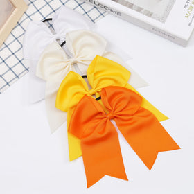 JOYOYO cheer team wearing assorted bows offering uniform, colorful look