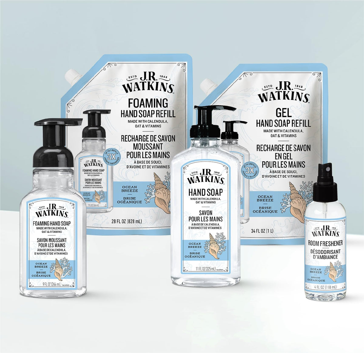 J.R. Watkins refill pouches beside standard dispenser to show scale