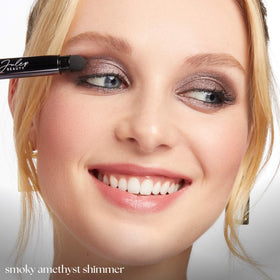 model applying Julep Smoky Amethyst across full eyelid for one-step shimmer look