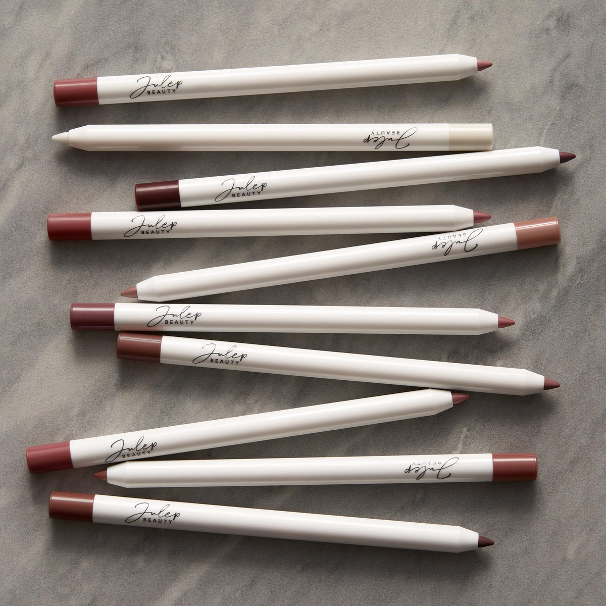 Julep lifestyle flatlay with liner and makeup items demonstrating everyday use