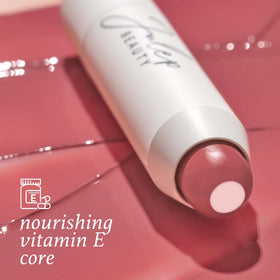Julep tube held in hand for scale, showing travel-friendly size benefit