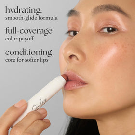 Julep balm held in hand displaying compact size and easy everyday use