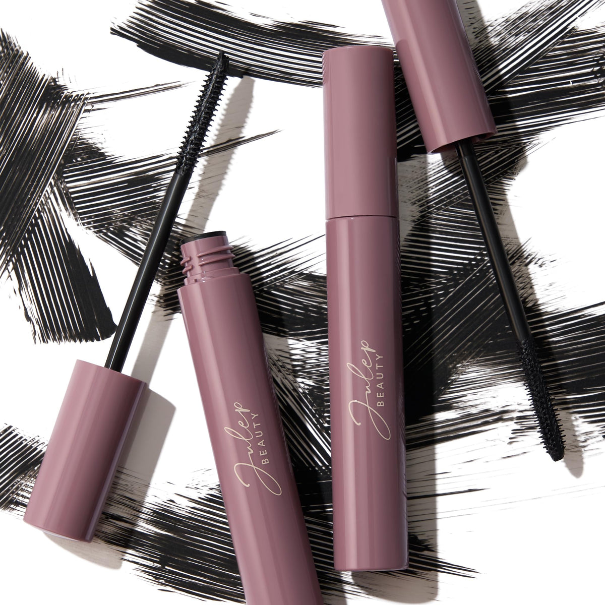 Julep applying mascara at mirror in lifestyle setting for everyday polished look