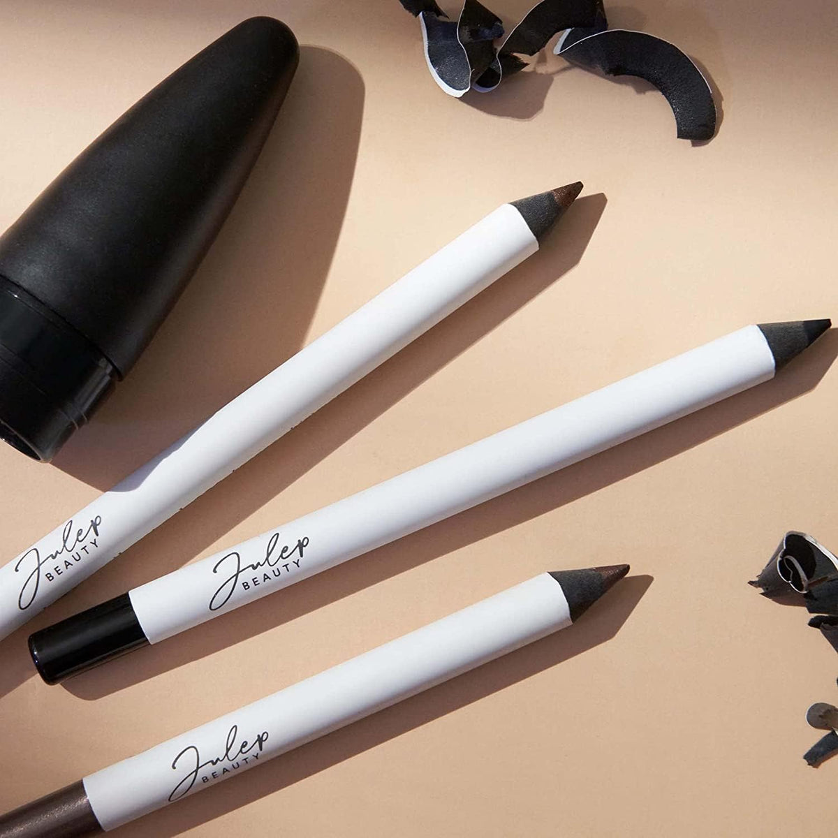 Julep next to coin for size comparison highlighting compact, travel-friendly pencil