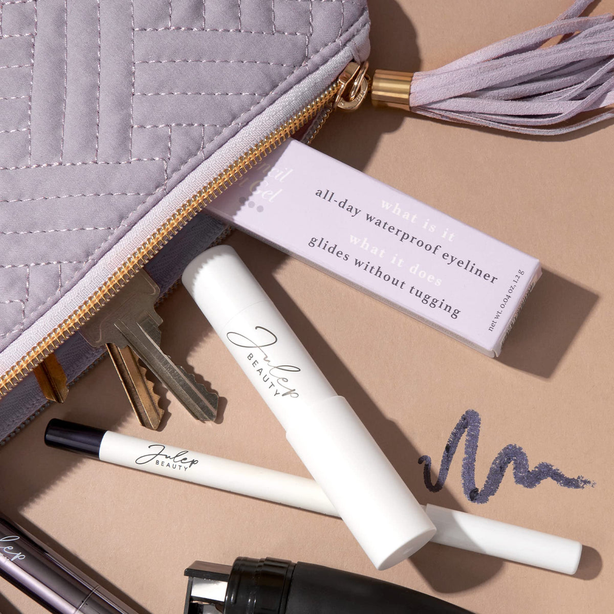 Julep pencil held in hand showing size and portable design for on-the-go touchups