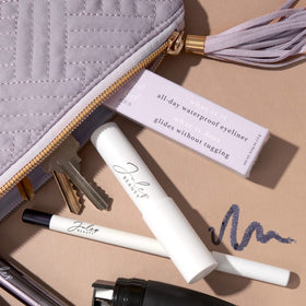 Julep pencil held in hand showing size and portable design for on-the-go touchups