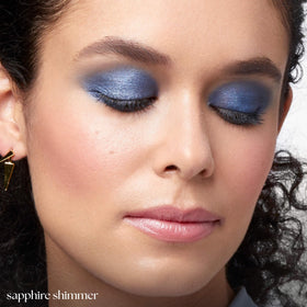 Julep eyeshadow stick being applied on eyelid for crease-proof shimmer
