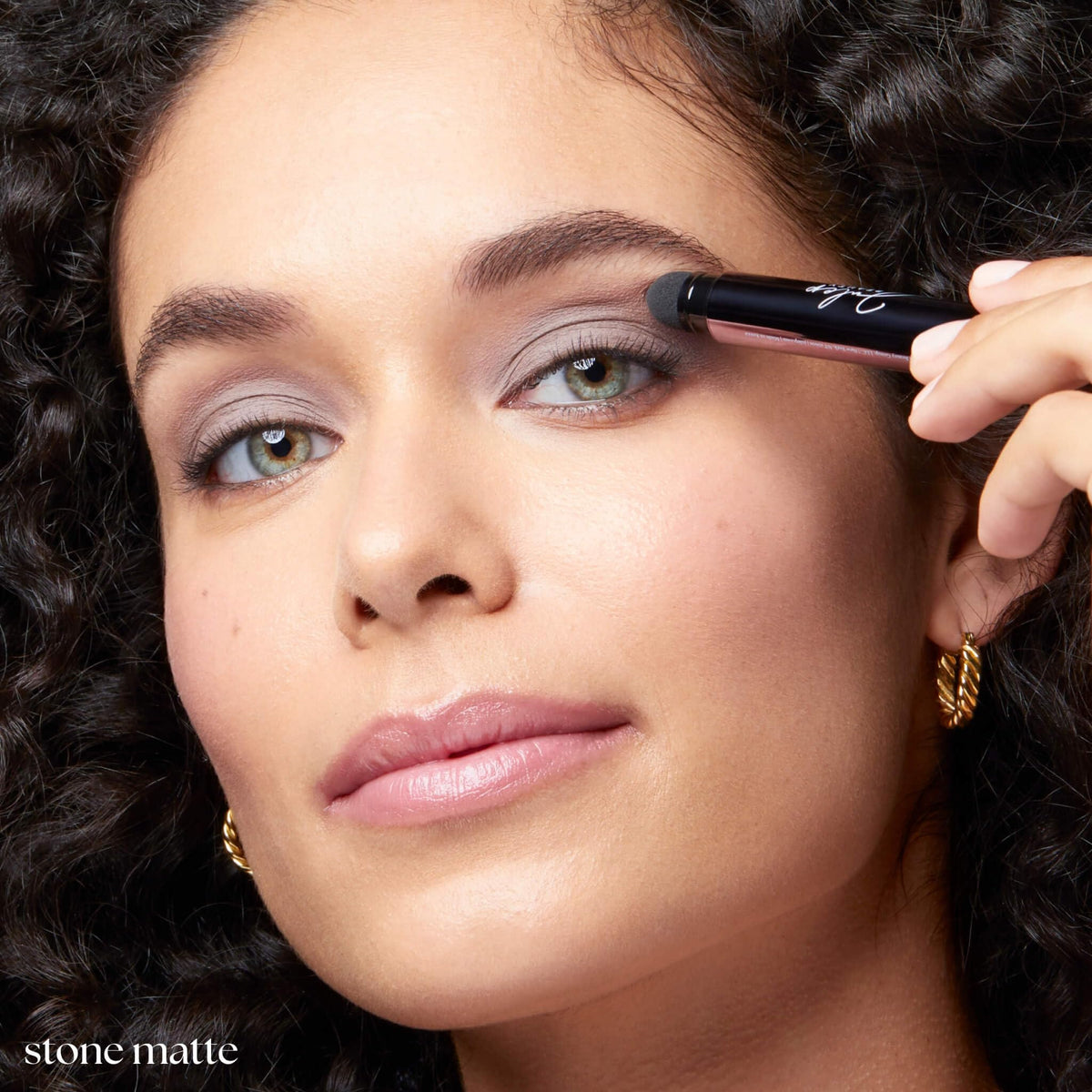 Julep applying Stone matte stick to eyelid demonstrating crease-resistant finish