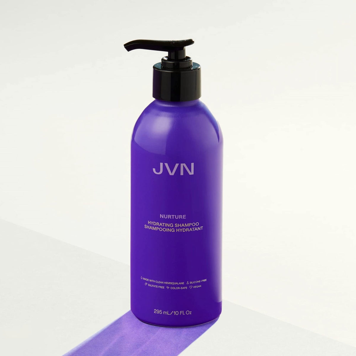 Person with smooth shiny hair after JVN shampoo for frizz control