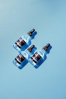 Kaleidoscope Hair Products dropper applying oil to scalp for targeted stimulation