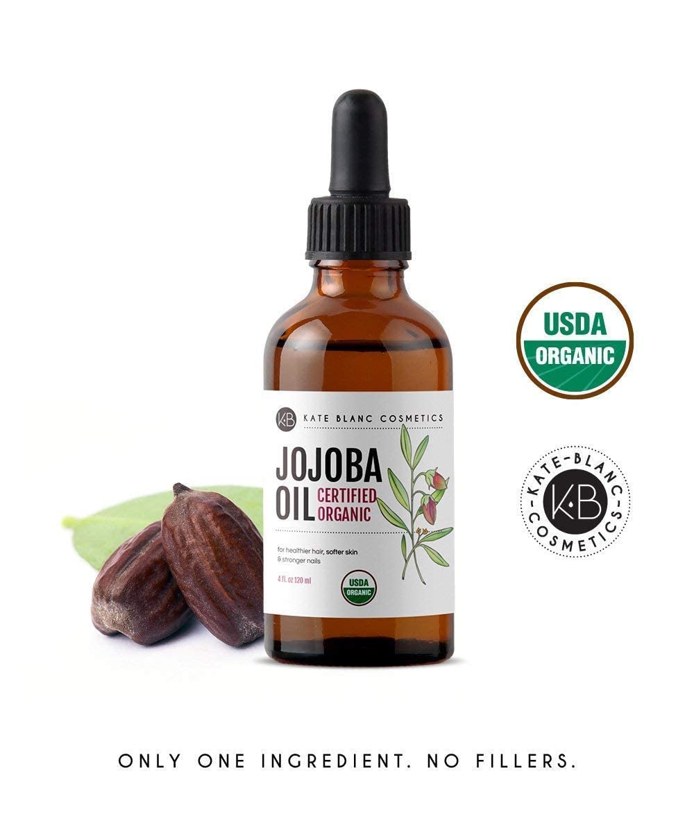 Kate Blanc 4oz jojoba oil next to measuring props showing compact travel-friendly size