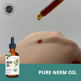 Kate Blanc pouring neem oil texture demonstrating smooth moisturizing benefit