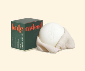 Kate McLeod Naked Stone MINI front view showing compact solid balm and eco-friendly packaging benefit