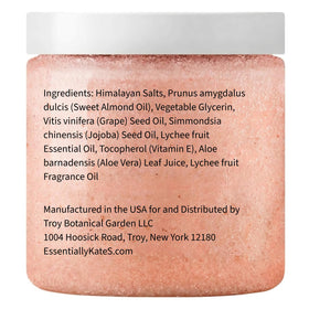 Almond oil bottle beside scrub jar illustrating natural oil infusion, reinforcing skin conditioning benefit