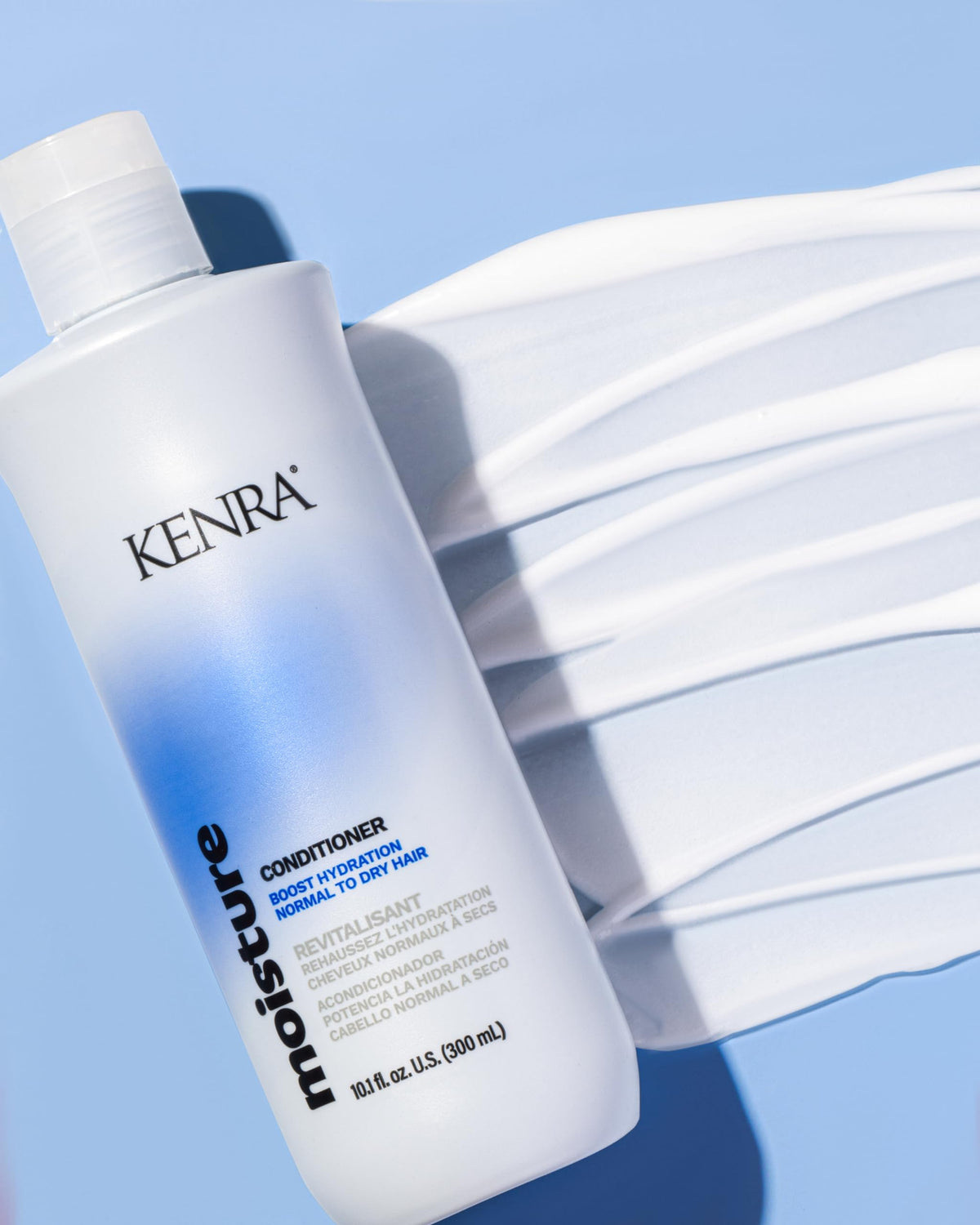 Kenra moisture conditioner creamy texture on palm for hydrating slip and detangling