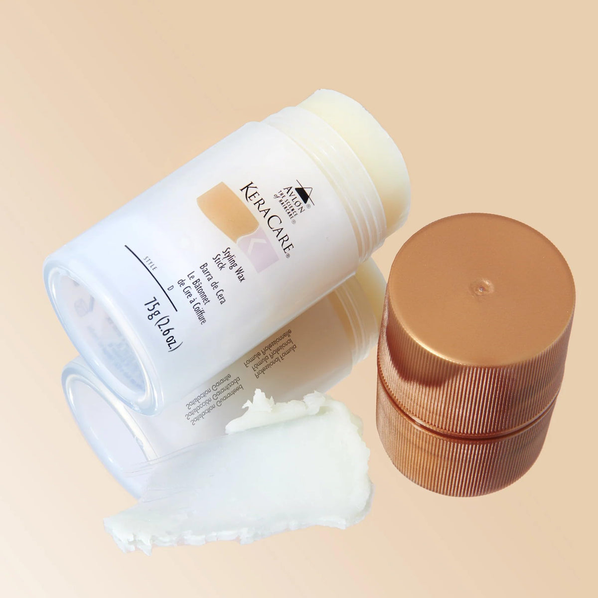 KeraCare wax stick held in hand for size comparison and travel convenience