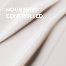 Kerasilk conditioner being applied to hands demonstrating slip and detangling benefit
