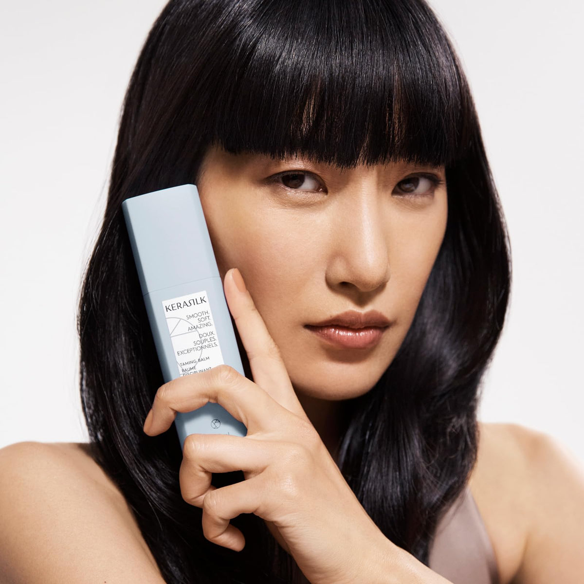 Kerasilk taming balm applied to towel-dried hair demonstrating improved manageability