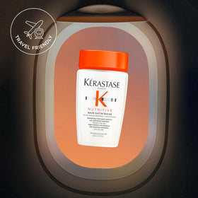 KÉRASTASE bottle in toiletry bag illustrating travel-ready moisture care