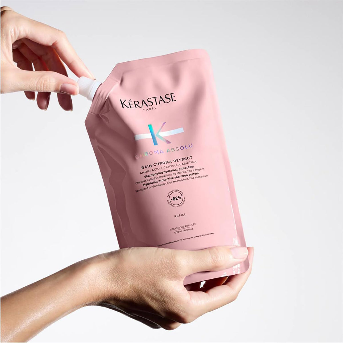 KÉRASTASE pouch beside Chroma Absolue masque showing paired-treatment shine benefit