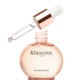 KÉRASTASE front packaging showing glossy anti‑frizz oil benefit