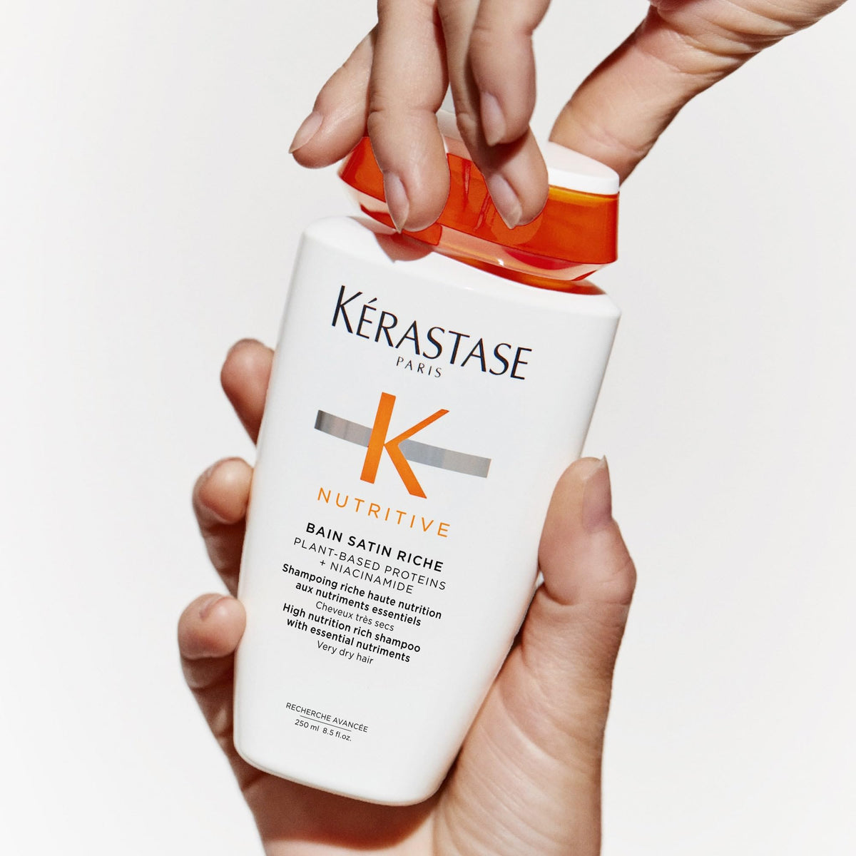 KÉRASTASE shampoo being applied to wet hair for easier detangling