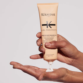 KÉRASTASE 5.07 fl oz jar held in hand to show real scale