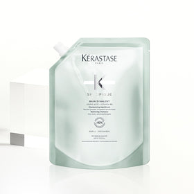 KÉRASTASE pouch next to original bottle showing compact refill size