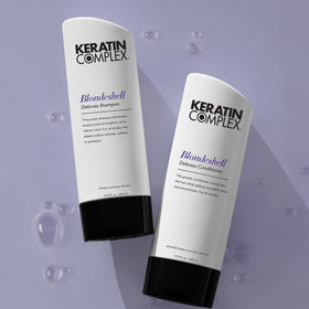 Keratin Complex bottle in hand showing 13.5 oz scale and travel readiness