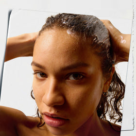Kiehl's creamy conditioner texture close-up demonstrating smooth spreadability and slip
