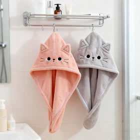 KIGOTWIN folded pink and gray towels stacked showing compact storage and travel-ready