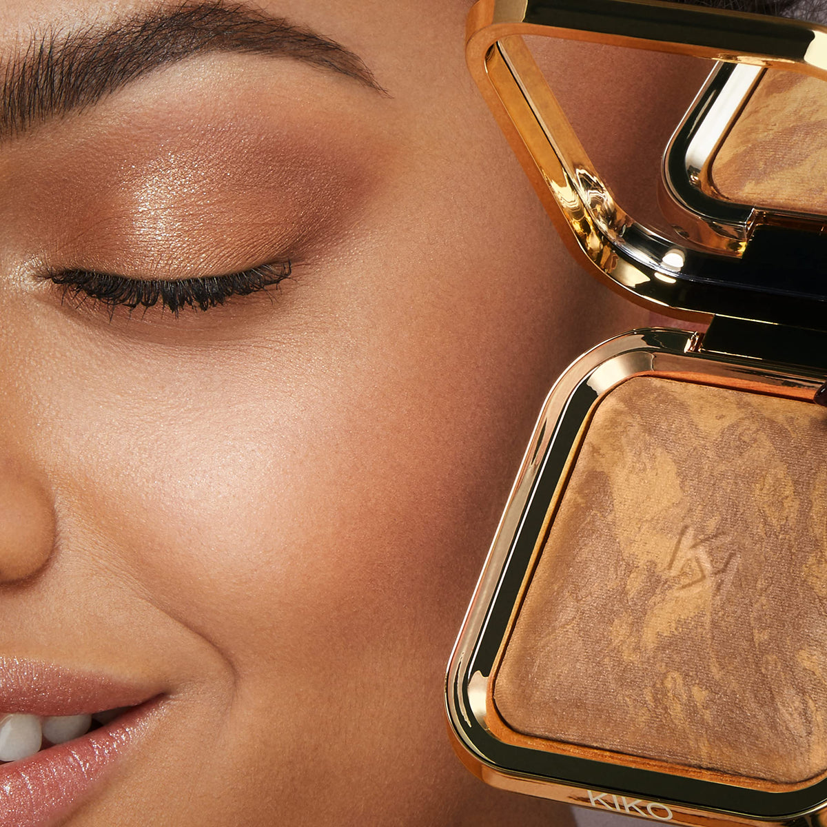 KIKO Milano bronzer applied with brush on cheek for natural sun-kissed warmth effect