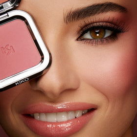 KIKO Milano blush in hand during touch-up showing mirror use benefit: quick on-the-go application