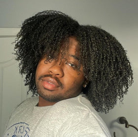 Kinky Curly bottles by bathtub illustrating clarifying routine and freshness