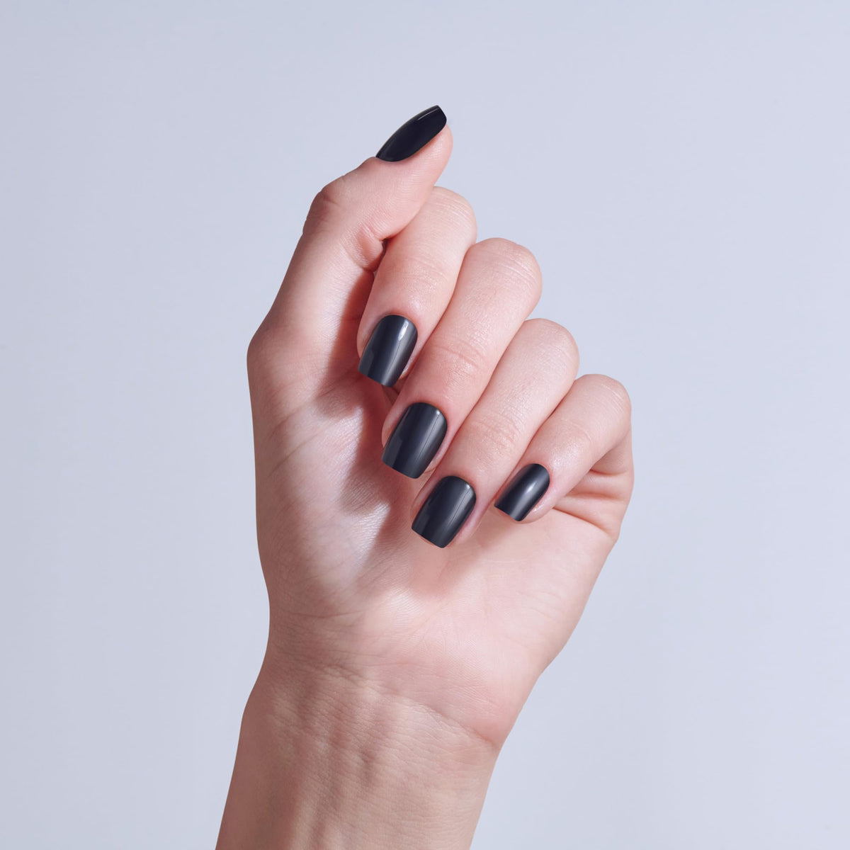 KISS close-up of a single black squoval nail highlighting smooth finish and depth