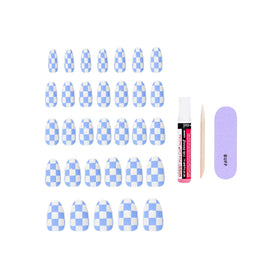 KISS 2g glue, manicure stick, and mini file arranged for quick use