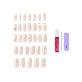 KISS Glam glue and tools laid out for quick at-home application