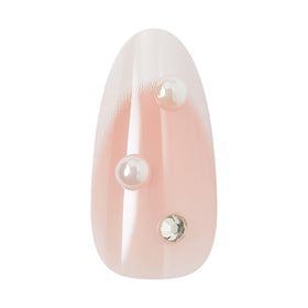 KISS nails in hand showing medium almond scale and wearable length