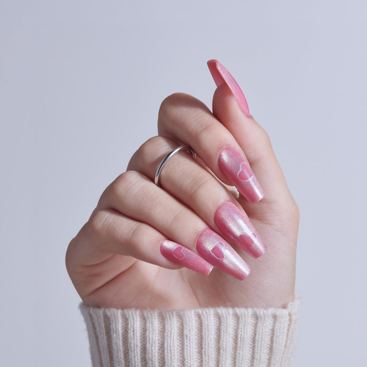 KISS close-up of single nail showing pink sugar chrome finish and detail