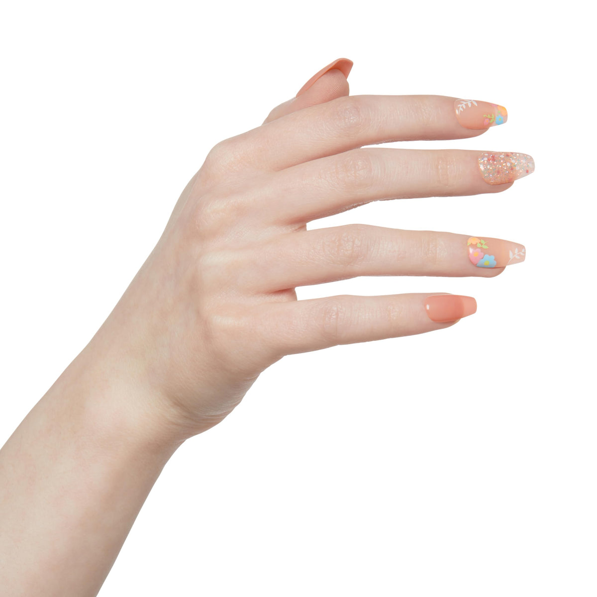 close-up of KISS coffin-shaped nude pink nail showing floral detail and finish
