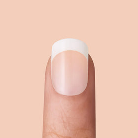 KISS hand holding nails to show Real Short squoval size and scale
