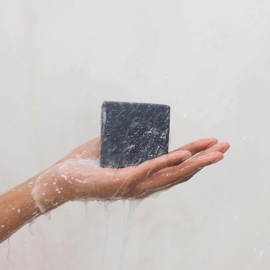 Kitsch charcoal bar with bath accessories implying routine upgrade