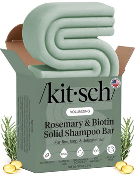 Kitsch front view of shampoo bar packaging showing compact travel-friendly design and benefits